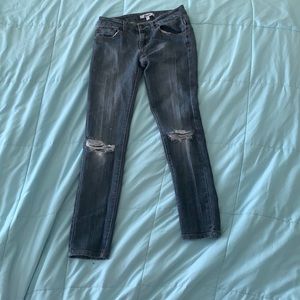 Ripped low rise blue jeans